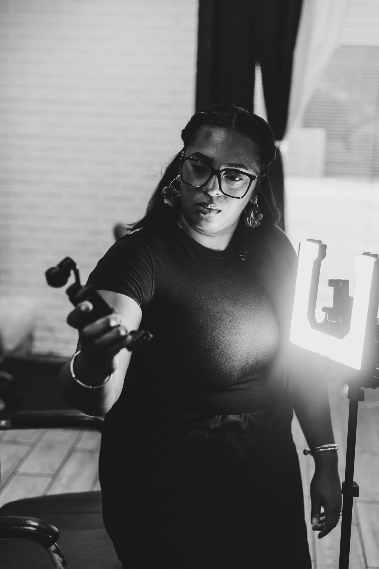 Danielle adjusting a ring light during a shoot